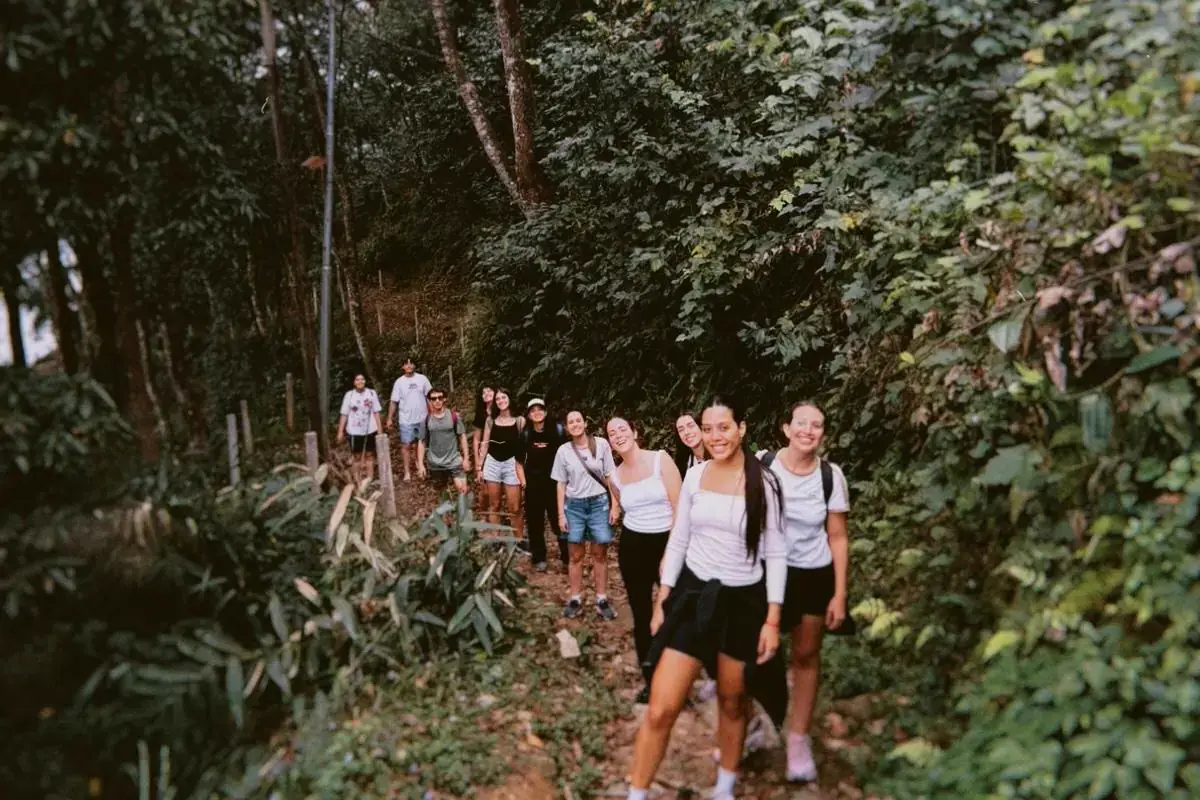 El grupo caminando en fila por un sendero de tierra entre la vegetación